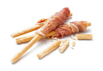 Tasty Italian Grissini with slices of jamon on white background