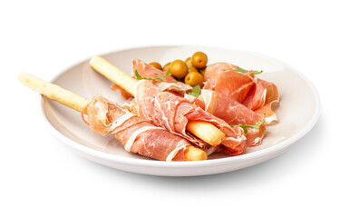 Plate of tasty Italian Grissini with jamon on white background