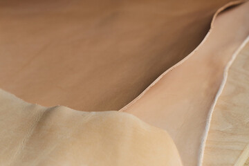 selection of top-notch beige leather cuts in different shades, demonstrating the range of colors available for designers and artisans. color grading and matching in leather industry. Grading the Hues