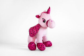 Close-up of a pink plush unicorn for children