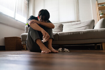 Man with mental health problem sitting on the floor to crying with stressed and depressed emotion
