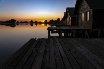 Line off wooden houses on a lake during the sunset