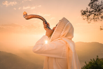 A Jewish man blowing the Shofar (ram's horn), which is used to blow sounds on Rosh HaShana (the Jewish New Year) and Yom Kippur (day of Atonement) - obrazy, fototapety, plakaty
