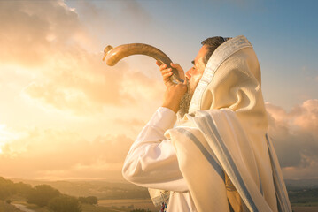 A Jewish man blowing the Shofar (ram's horn), which is used to blow sounds on Rosh HaShana (the...