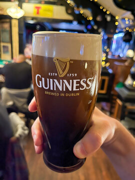 Glass of cold Guinness stout on the bar. Toronto, Ontario, Canada. 2022-11-05
