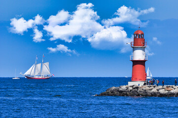 The red and white colored Lighthouse Ostmol at the port entrance of Warnemünde, Rostock, Germany