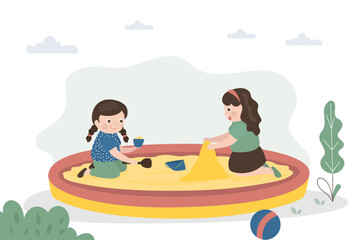 Happy girls play in sandbox. Children build pyramids and sandcastles. Cute preschoolers on playground. Kids games, entertainment, development of imagination.
