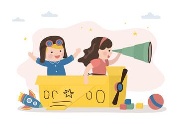 Cute kids sitting in cardboard box and playing airplane pilots. Children flies on an imaginary aircraft. Preschooler game, imagination, creativity and dreams.
