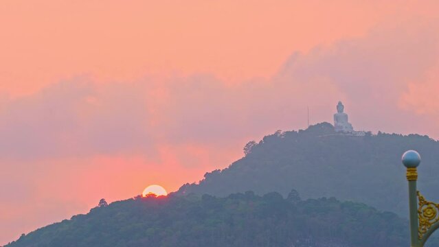 Phuket big Buddha in beautiful sunset..the sun shines through the clouds..The beauty of the statue fits perfectly with the charming nature..Gradient color. sea texture, .cloud scape background.
