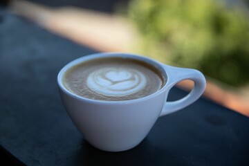 Closeup shot of a latte in a white cup.