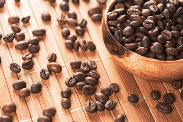 Frying coffee mesh in wooden bowl. Brown granules of medium roasting.