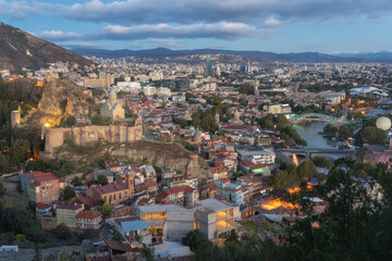 Fototapeta premium Aerial of Tbilisi, Georgia from Tabor Monastery of the Transfiguration during sunrise