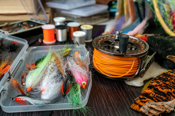 Fly fishing flies in a box, a set of various accessories and materials for knitting fly fishing...
