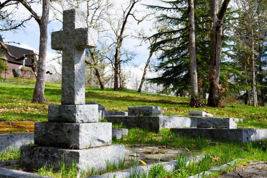 An image of a large stone cross in a historic cemetery on Vancouver Island.