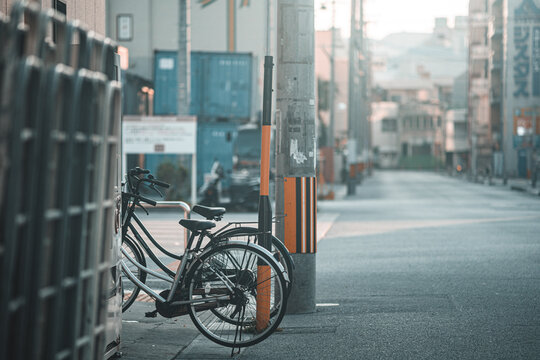 Selective focus of bicycles parked on the sidewalk on a sunny day in Chatan, Japan
