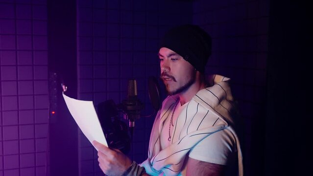 voice actor is re-recording in isolation booth of audio record studio, dubbing in post-production