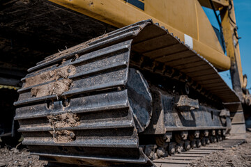 Excavator with shovel digs the ground for the foundation at constuction area.