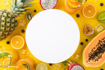 A symphony of fruity goodness. Top flat lay view photo of mixed exotic fruit cocktail in glass jar dragon-fruit, kiwi, papaya, pineapple, orange, lime on yellow background with empty circle for text