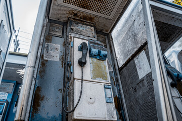 Old and dirty street phones at the city landfill