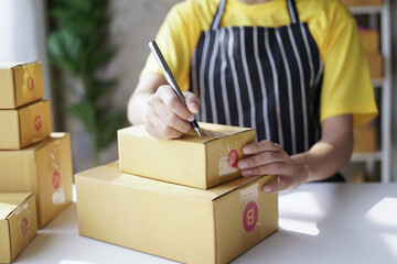 startup girl Small SME business owners work with laptop computers at work. with parcel paper boxes for delivery to customers online selling, Ecommerce,