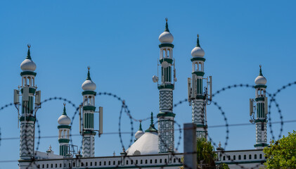 Fototapeta na wymiar Blurred barbed wire in foreground at Habibia Soofie Masjid Mosque in Athlone near Cape Town South Africa