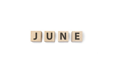june word on wooden cubes on a white background