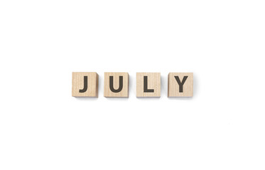 july word on wooden cubes on a white background