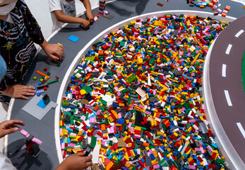 View on multi color plastic bricks at the table.