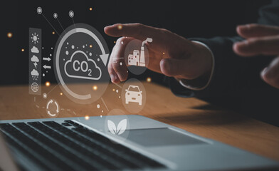 Entrepreneur hand point at digital screen dashboard while control and reduce carbon emission for...