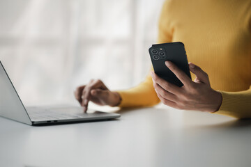 A person holds a mobile phone to use social media on a smartphone, communicating via the Internet on a smartphone. The concept of using technology in communication.