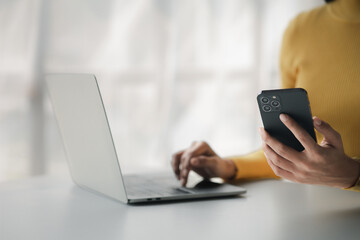 A person holds a mobile phone to use social media on a smartphone, communicating via the Internet...