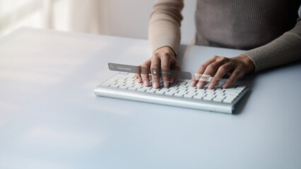 An individual is typing on a laptop keyboard showing a hologram interface to a member login, a businessman is going to access the company's membership system, check the information of the parties.