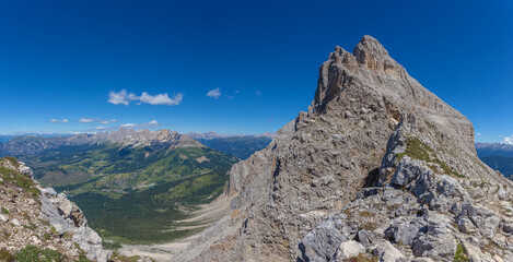 Panoramic view of famous Dolomites mountain peaks. Northern slope of Mount Latemar and in the background the Catinaccio massif, South Tyrol, Italy. Awesome mountain panorama