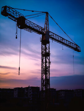 Construction crane at twilight, vertical photo. High quality generative ai