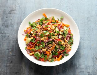 Asian Quinoa salad with fresh vegetables, peanuts and herbs. Healthy food.