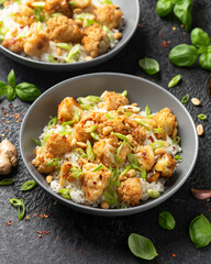 Kung Pao Cauliflower with rice, peanuts and spices. Healthy vegan food.