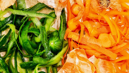 Closeup vegetable scraps ready for composting. Vegetable peelings on wrapping paper, set aside for...