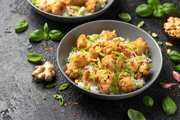 Kung Pao Cauliflower with rice, peanuts and spices. Healthy vegan food.