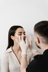 ENT doctor examines and palpates the nasal septum for septoplasty surgery. Septoplasty is the surgical correction of defects and deformities of the nasal septum.