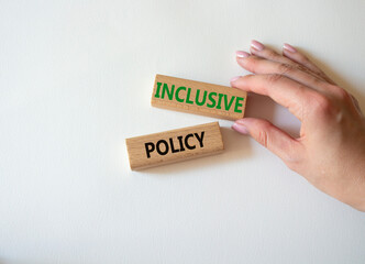 Inclusive policy symbol. Concept word Inclusive policy on wooden blocks. Beautiful white background. Businessman hand. Business and Inclusive policy concept. Copy space