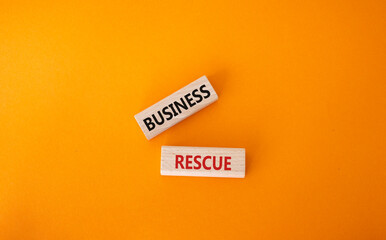 Business rescue symbol. Wooden blocks with words Business rescue. Beautiful orange background....
