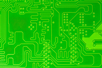 Electronic equipment board, computer board circuits. Information tracks from a board. Green board with yellow trails.