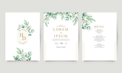 Set of white floral wedding invitations and green leaves