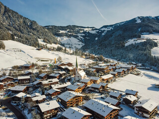 Fototapeta na wymiar Aerial view Alpbach town in Kufstein, Tirol. Austria by drone. Alps mountains. Winter. Snow.