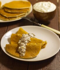 Pancakes with mushrooms on a white plate with a fork