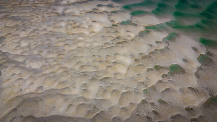 beach, low tide, top view. Unusual sandy texture.
