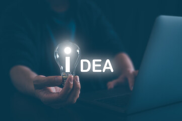 idea creativity concept, man holding light bulb with word idea, inspiration and innovation new technology