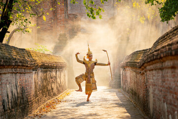 Khon or traditional Thai classic masked from the Ramakien characters as man dance in front of ancient building with tradional weapon. - obrazy, fototapety, plakaty