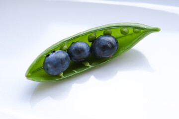 Pea pod with blueberries