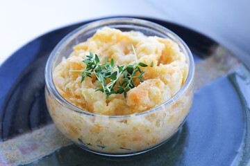 Mashed Potatoes in glass bowl on dark plate